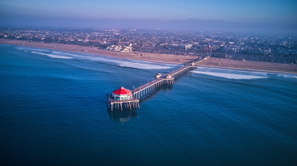 Beautiful aerial shot of a orange county ca pier, looking towards the mountains